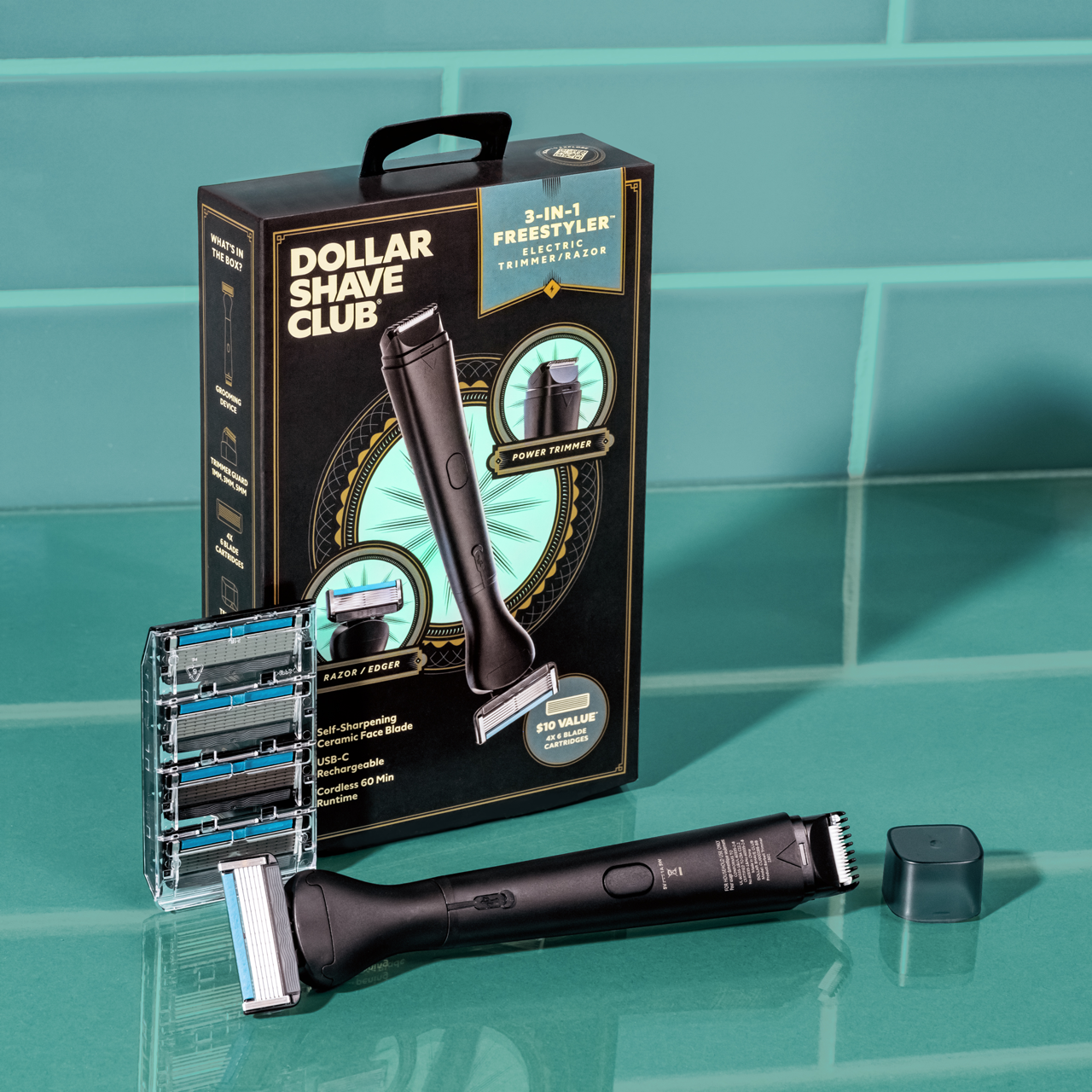 A photo of the 3-in-1 Freestyles with trimmer cap, 4 ct cassette of Club Series 6 Blade Razors, and the packaging box on a teal green counter with teal green tile in the background