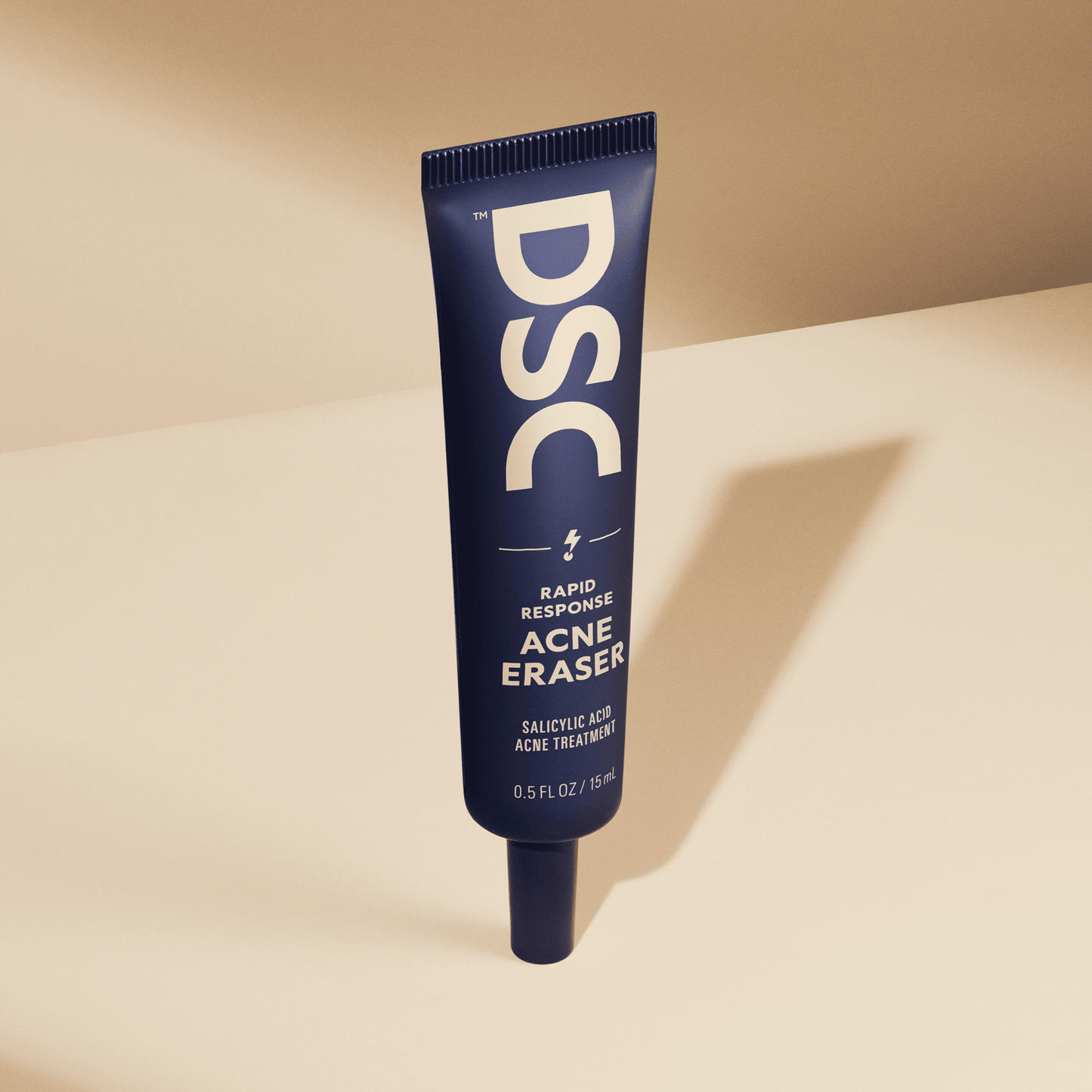 Dollar Shave Club Acne Eraser against tan backdrop.