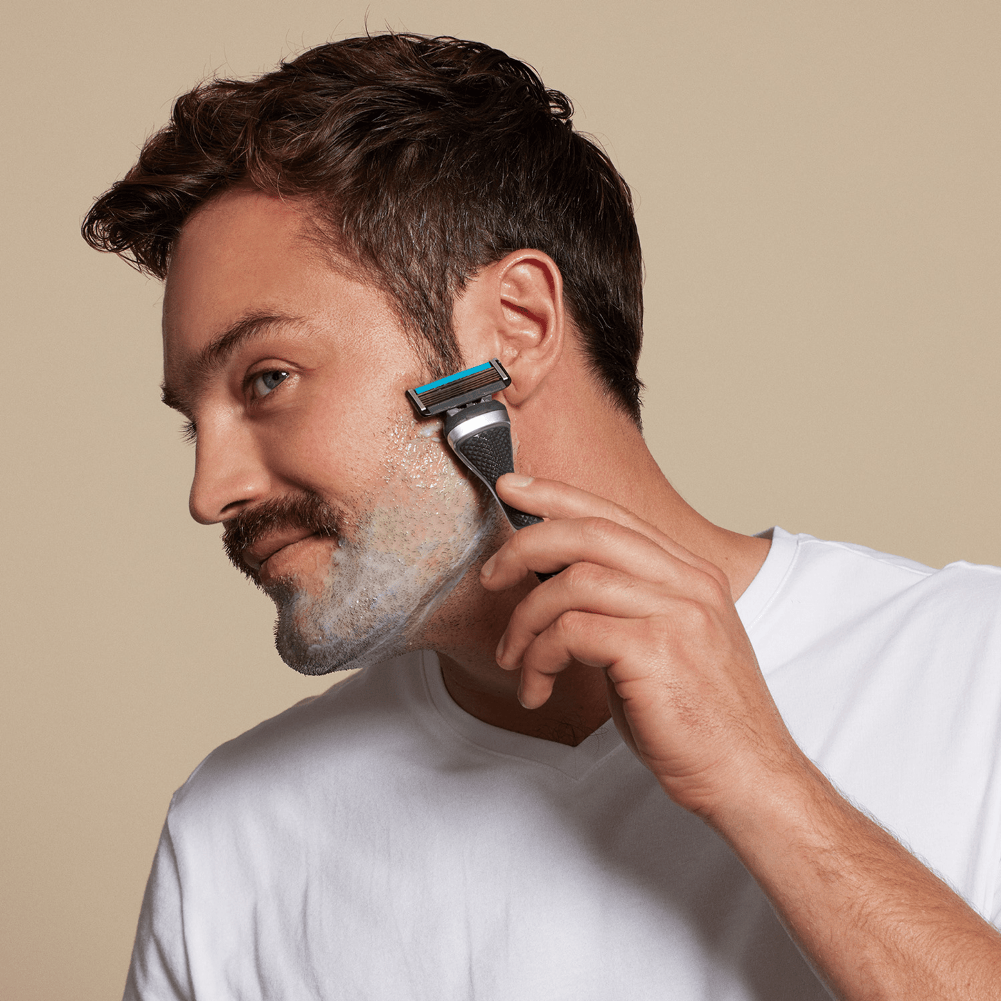Man shaving with Dollar Shave Club Club Series Six blade razor.