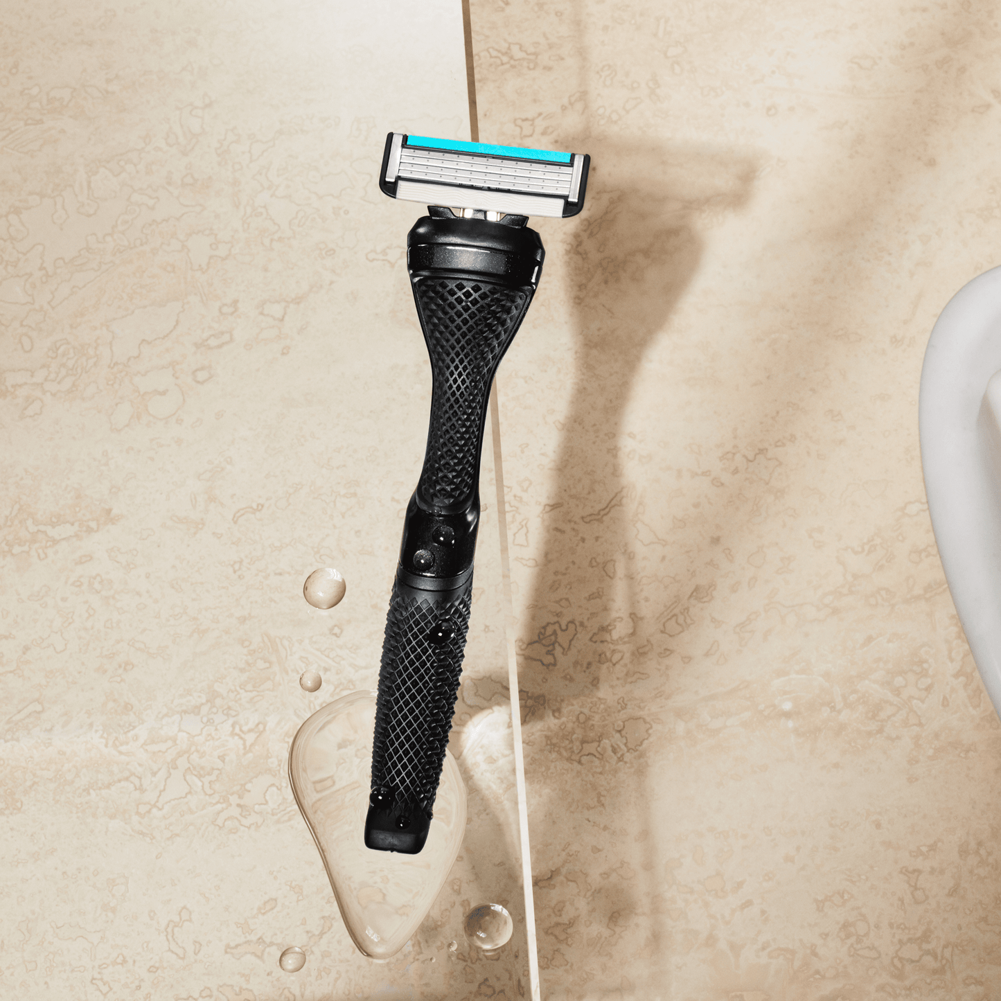 Dollar Shave Club Diamond Grip Handle Black product image with tan backdrop.