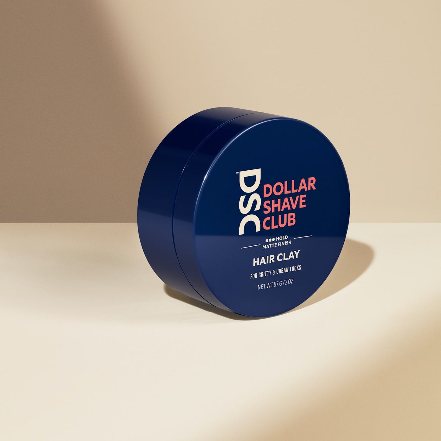 Dollar Shave Club Hair Clay against blank backdrop.