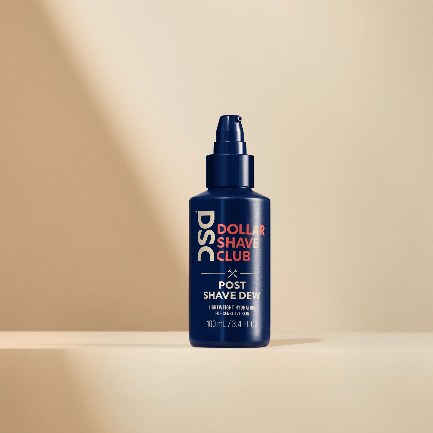 Dollar Shave Club Post Shave Dew product image against tan backdrop.