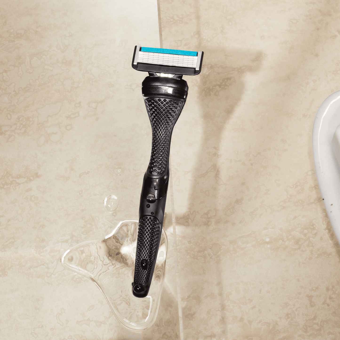 Dollar Shave Club Smooth Handle Black product image with tan backdrop.