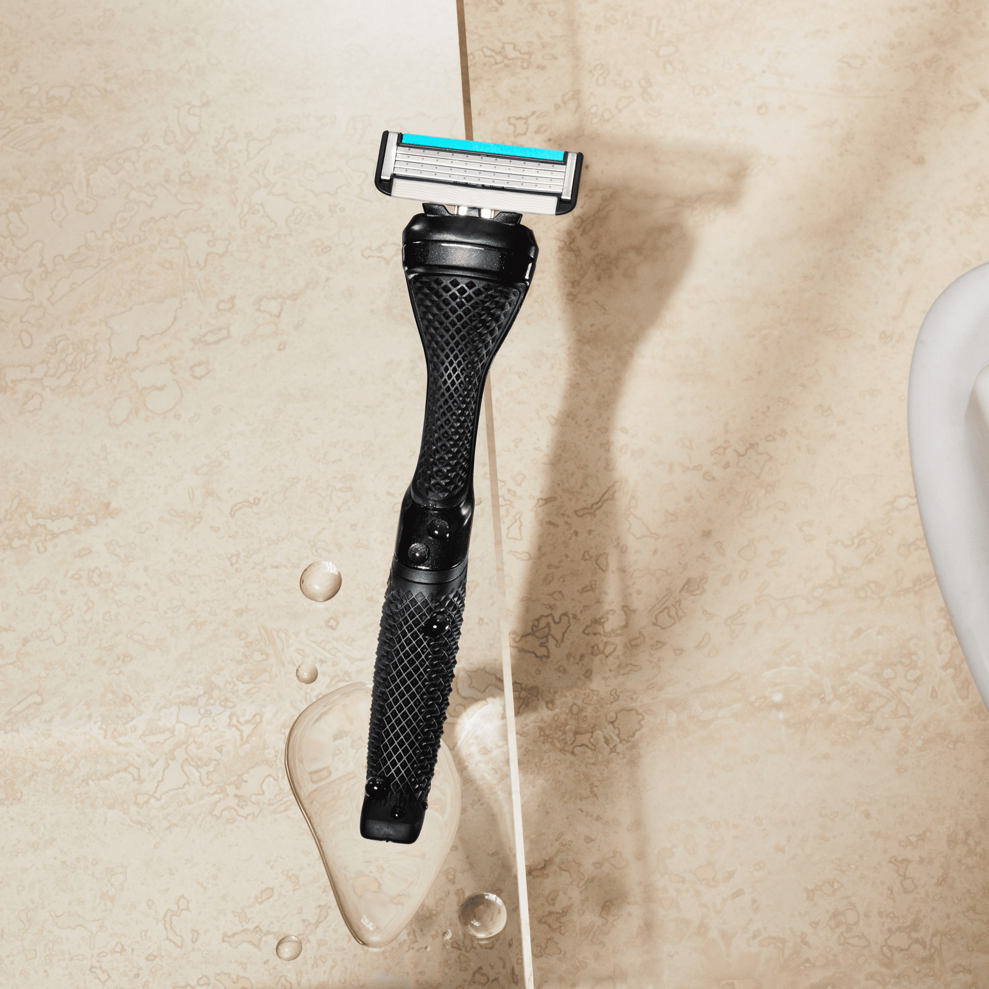 Dollar Shave Club Diamond Grip Handle Black product image with tan backdrop.